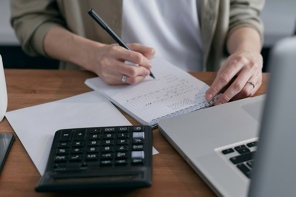 LamberMakingBudget-(1200px) Close up of person writing on paper